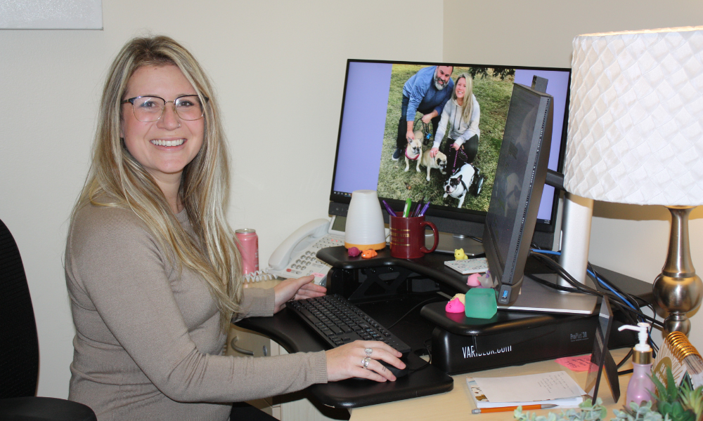 Regina Wine-Nash at Desk