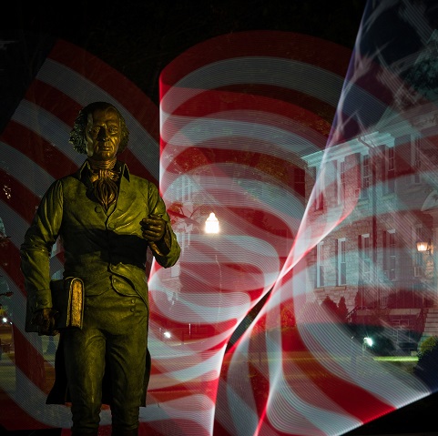 Photo of James Madison statue with American flag waving