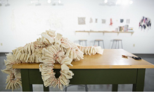 Performance area from Nava Levenson's Senior Exhibit, Duke Hall Critique Space, B.F.A. Alumni 2017. Cast ceramic egg cartons and handmade crocheted pasta.