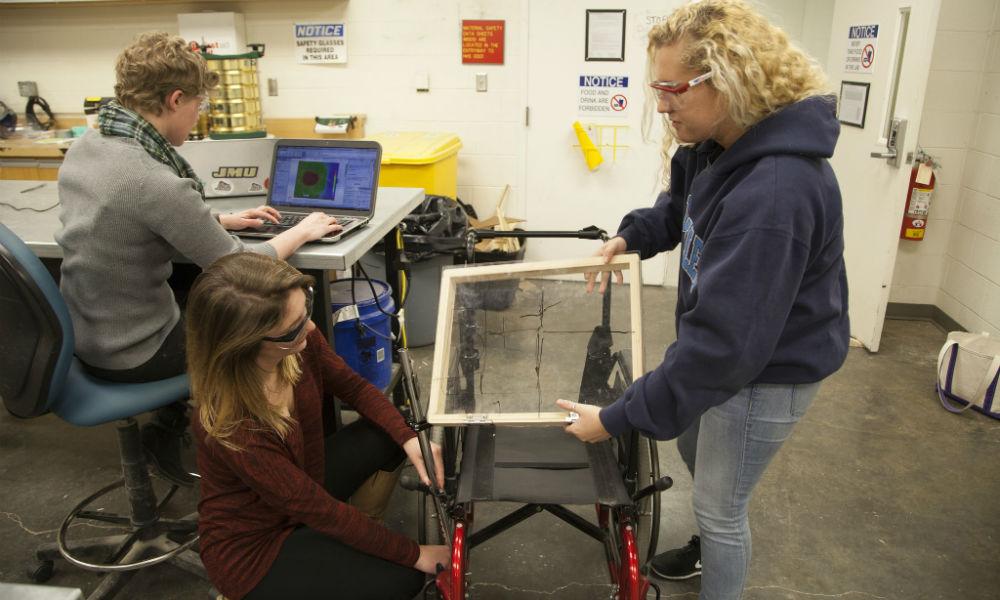 Engineering students working on wheelchair