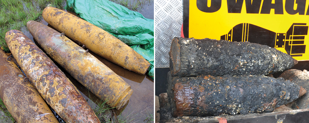 Two images, one of four rusting metal tubes laying on a wet surface, one of two crusty black cylinders sit in front of a sign with a bomb printed on it.