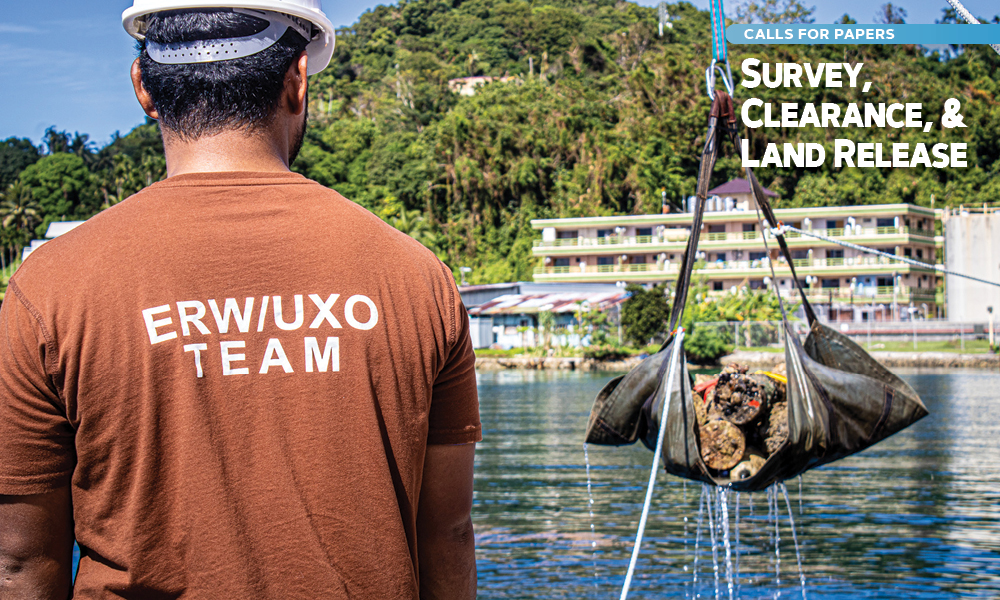 A man wearing a hard hat and shirt that says "ERW/UXO Team"; superimposed text reads "Survey, Clearance, & Land Release".