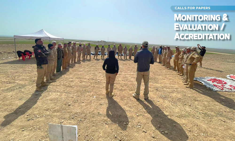 A group of people stand in a half circle and face a man and woman; superimposed text reads "Monitoring & Evaluation / Accreditation".