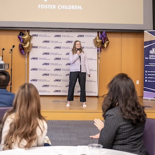 Caroline Stoaks on stage presenting in the Forum