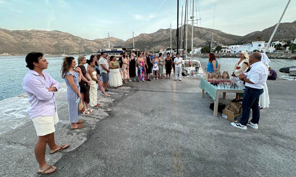 Students arrive in Milos, Greece and are standing in line at the marina.