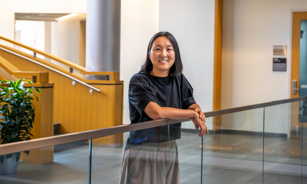 Joo Kim ('22M) stands on the balcony in Hartman Hall.