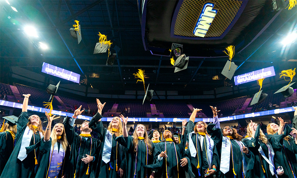 Graduates celebrate their accomplishment at Commencement in the Atlantic Union Bank Center.