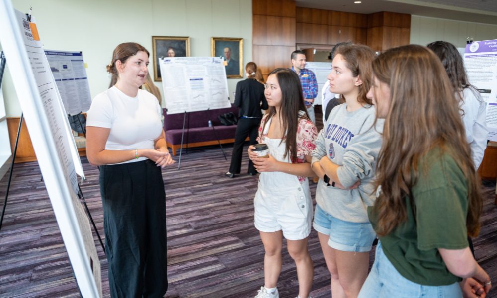 A student presenting during the poster session at the 2024 Annual Graduate School Showcase. Participate in the Graduate School Showcase for the opportunity to practice presenting your work. 