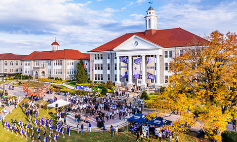 Aerial of JMU's Wilson Hall and Quad full of people