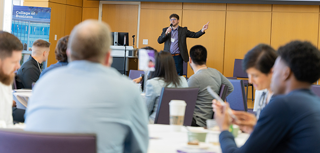 A speaker presents to an engaged audience at a SSLS event.