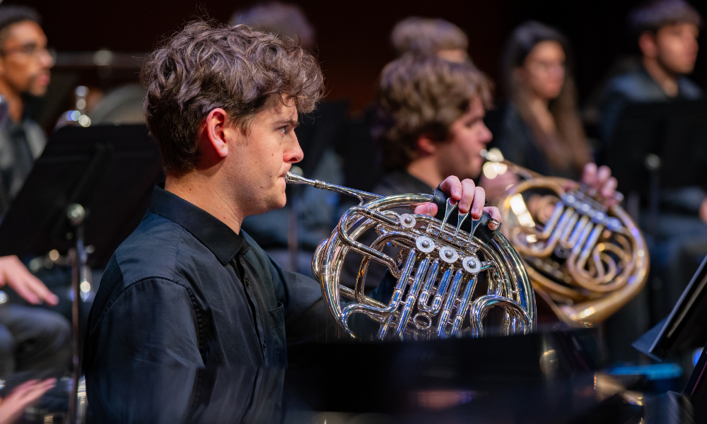 man playing horn in a wind ensemble