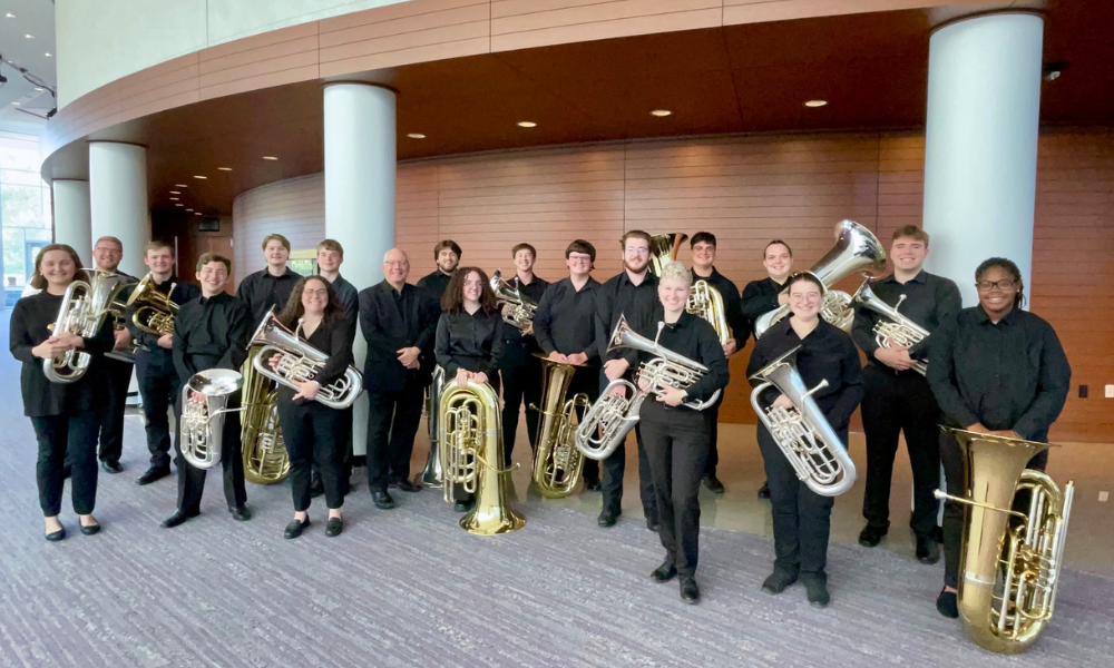 tuba and euphonium players holding their instruments