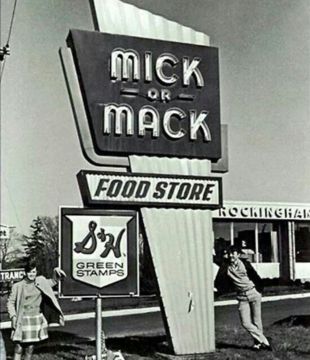 Vintage sign for Mick or Mack Food Store featuring a retro design and green stamps promotion.