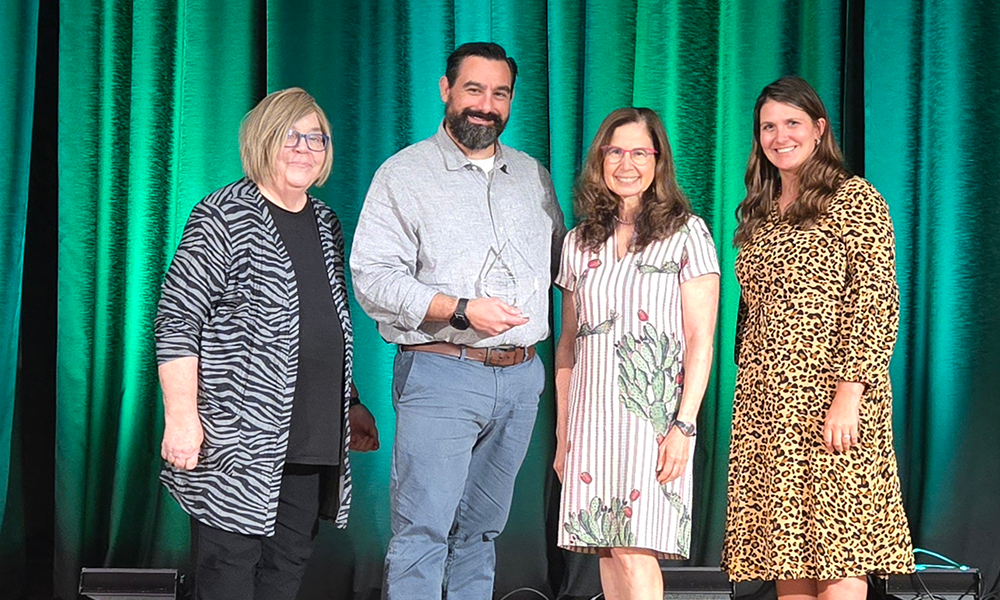 (From left) JMU's Lynne Stover, John Kruggel, Nan Morrison, president and CEO for the Council for Economic Education, and JMU's Lauren Shifflett, accept the Albert Beekhuis Award, Thursday, Sept. 26, 2024, at the CEE’s 63rd annual Financial Literacy and Economic Education Conference in Cleveland, Ohio.