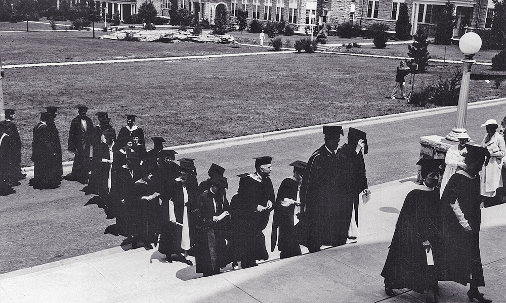 Black and white photograph of 1960s graduates on the steps of Wilson Hall