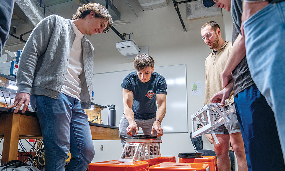 Sophomore Engineering students, under the direction of professor Steven Woodruff, load-test cardboard bridges that they built and analyzed.