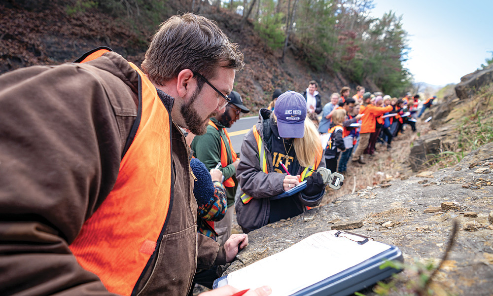 Geology students survey rock formations in Franklin, West Virginia, as part of their fieldwork. The class examines the stratigraphic, structural, and tectonic principles that control the character and distribution of rocks.