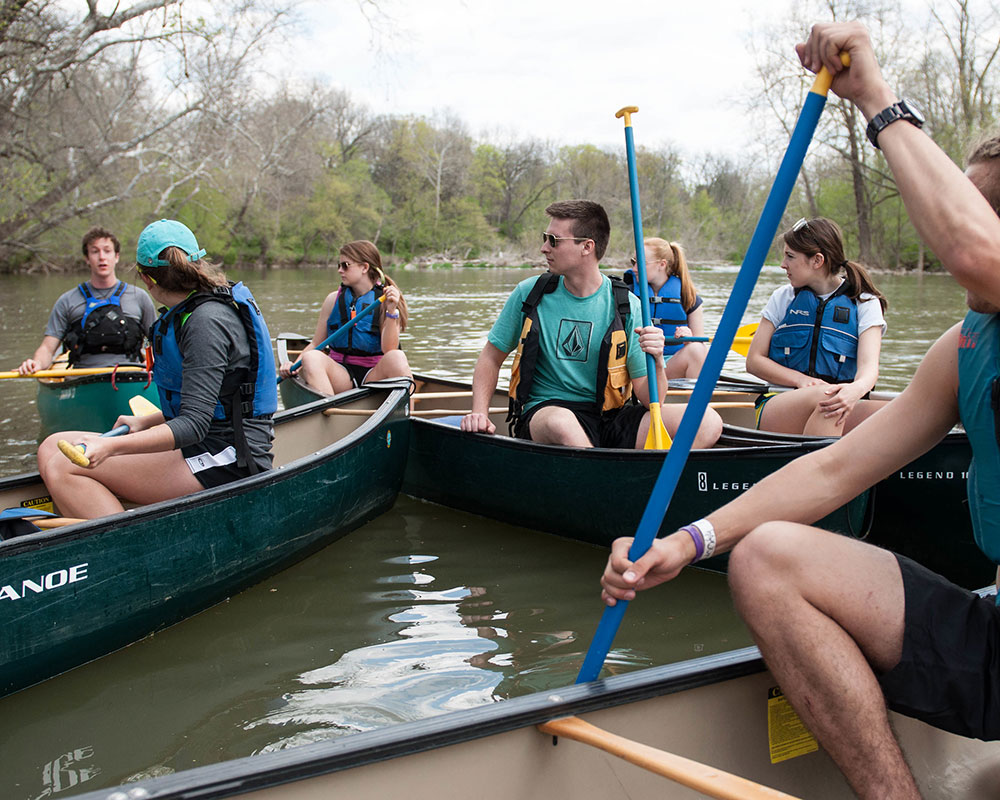 students on canoes