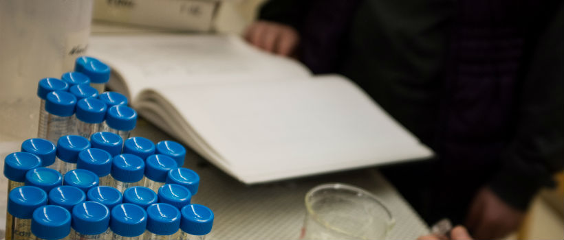 Glass vials and book on a chemistry lab table