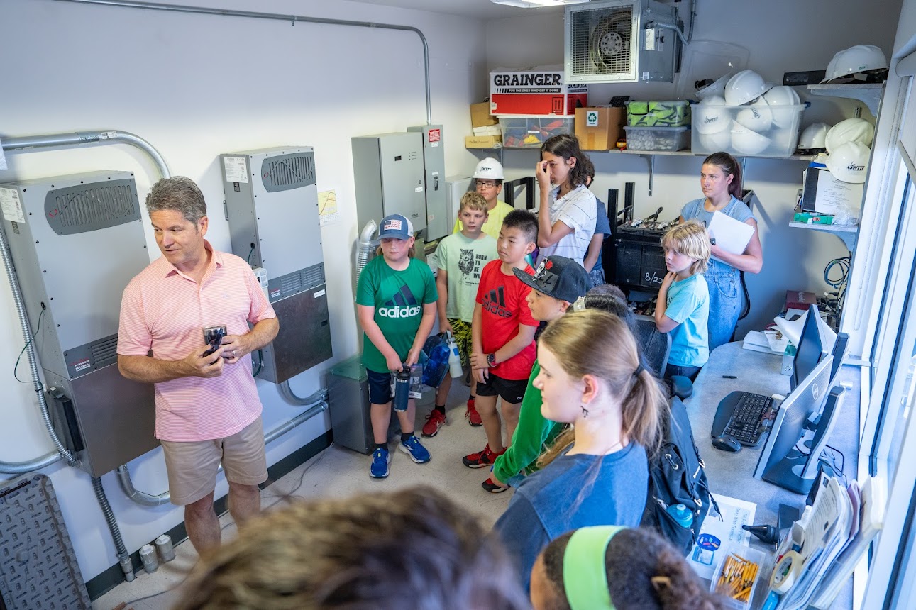 group of people inside wind facility's building