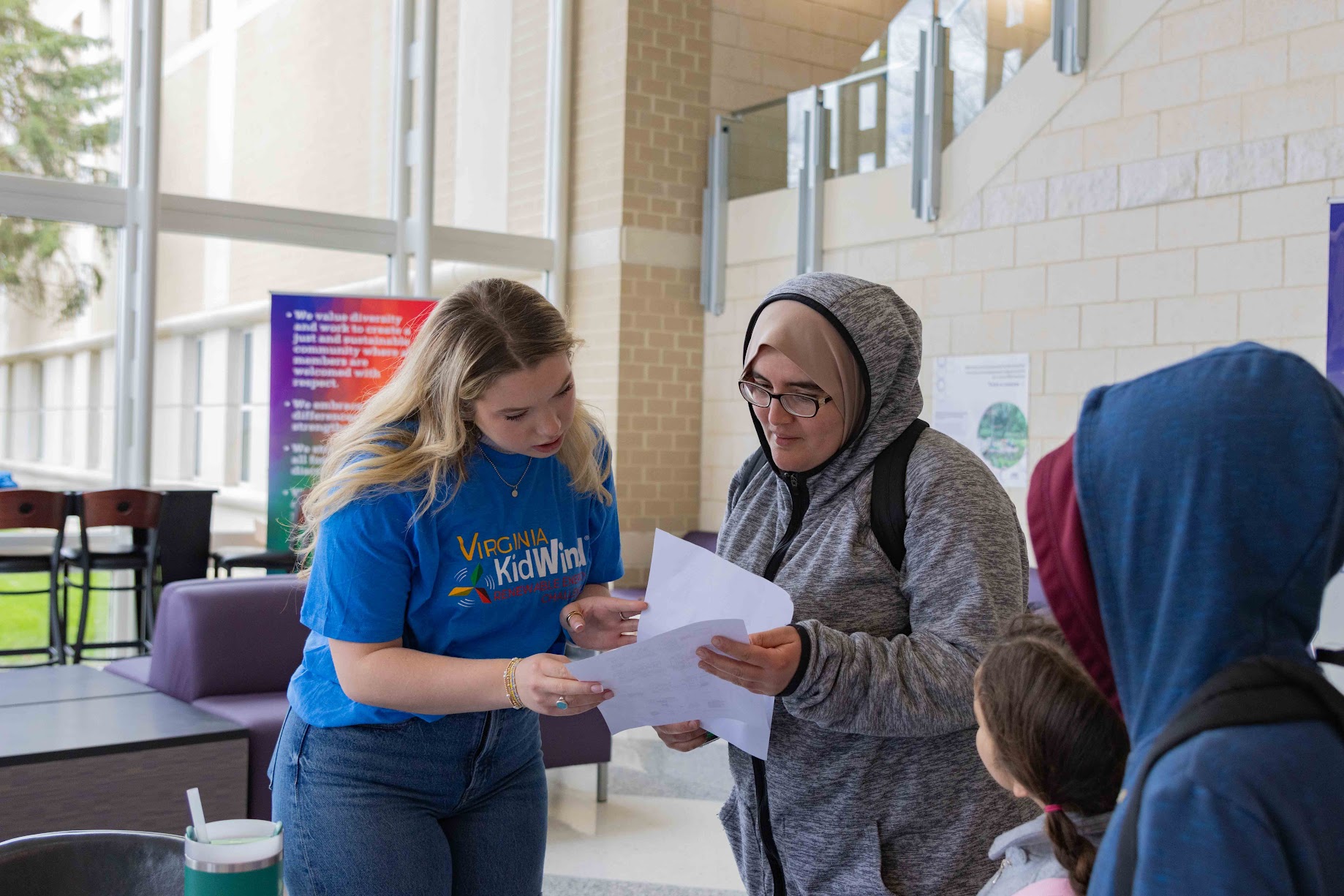 Kidwind volunteer directing an attendee