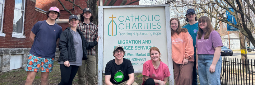 catholic charities group with sign