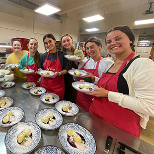 Students pose with dishes they made.