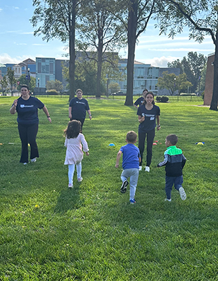 Student interns and participants play outside for the Healthy Kids program