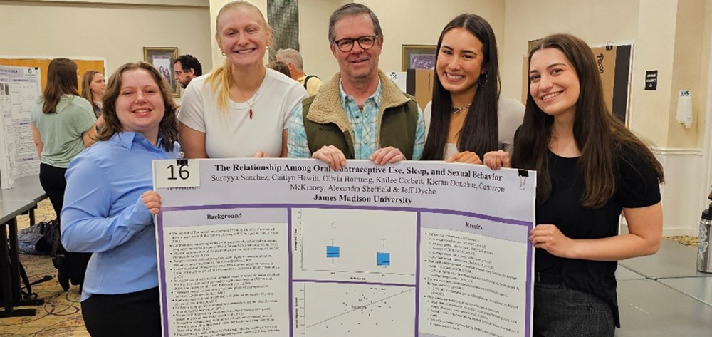 Students present research poster with Professor Jeff Dyche