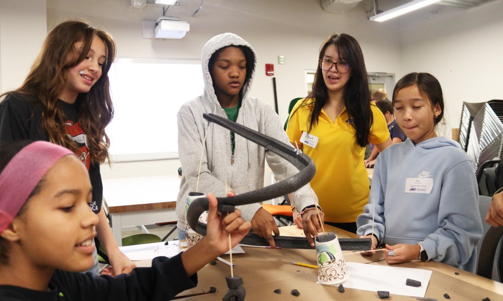 Female middle school students participating in an engineering project