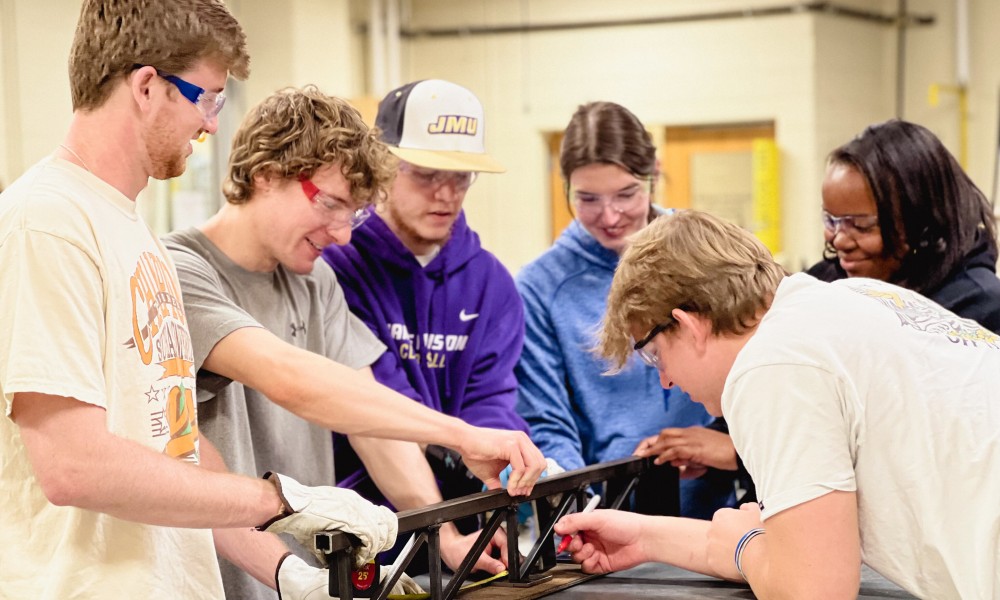 Engineering students building a bridge