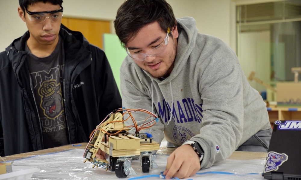 Engineering students presenting 231 robotics projects