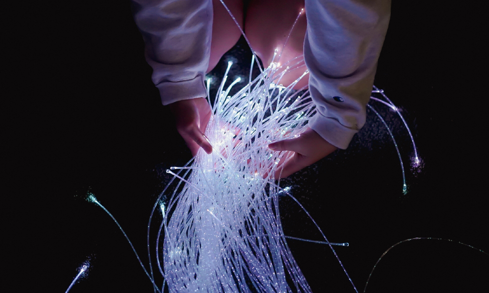 Student holding color-changing fiber optic strands in JMU's Sensory Room