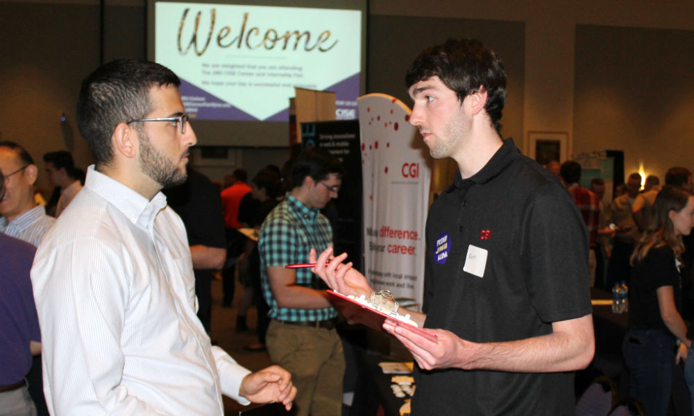 Males communicating at CISE Career Fair