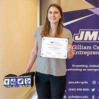 Anya Strogonova stands with a certificate