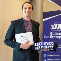 Nicholas Jordan standing with a GCFE certificate.