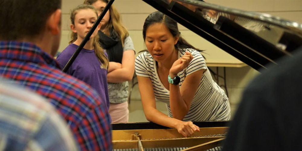 Piano technician talking about inside of piano