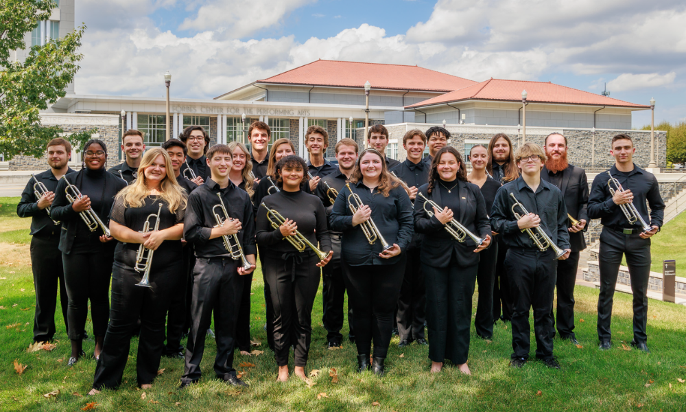 trumpeters standing outside holding trumpets