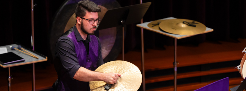 man playing crash cymbals