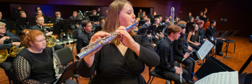 Flutist performing with wind ensemble