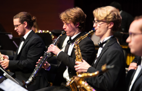 young man playing soprano saxophone