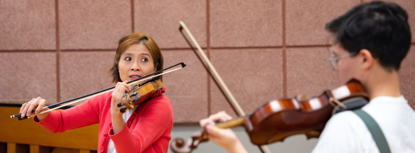 professor playing violin in class