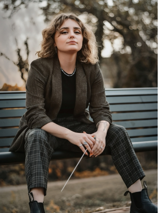 Woman sitting on bench with conducting baton