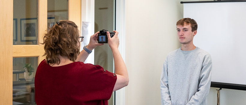 Taking a passport photo of a student