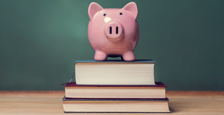 piggy bank on top of stack of textbooks