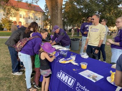 families decorating cookies outside