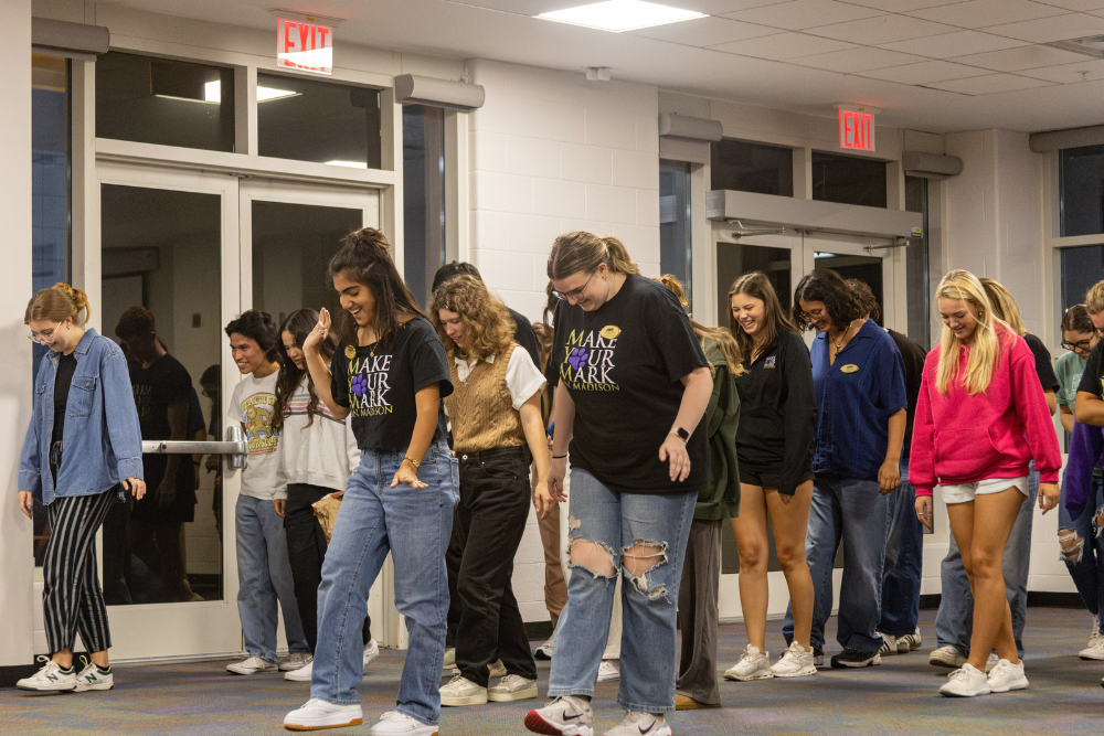 members of Make Your Mark dancing at an event