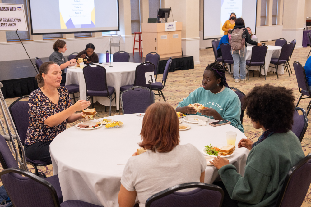 students and staff seated at tables enjoying their lunch at the student org leaders lunch