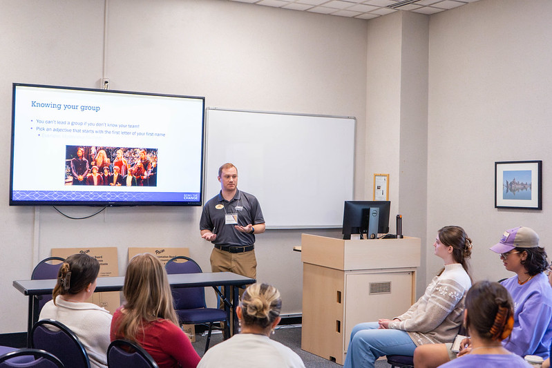 Photo of a presenter speaking to an audience of students.