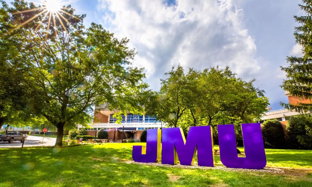 A large sculpture of the JMU letters in front of the Unions building